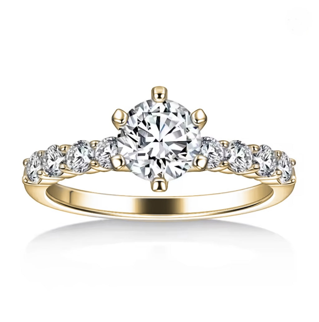 Gold ring with a large diamond and smaller diamonds on a white background